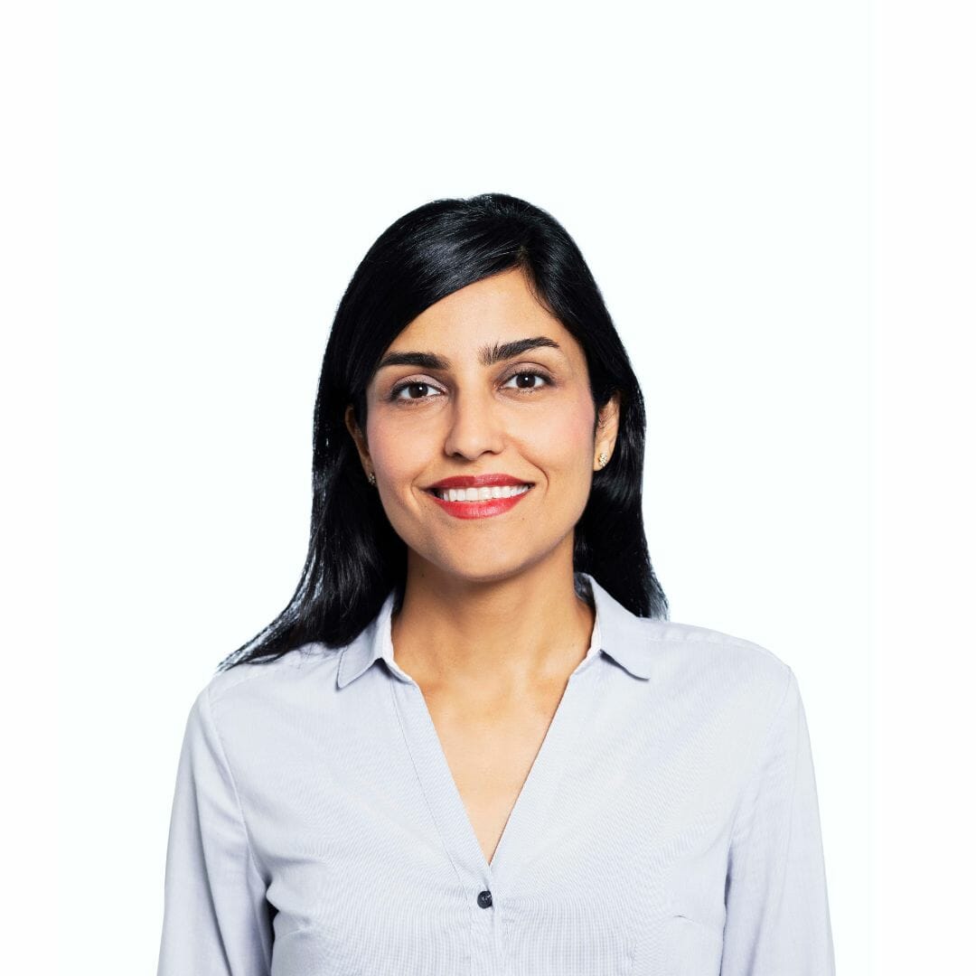 Sadaf Jafari is SGA's director of sustainable design, she has dark hair, red lips, and a grey blouse